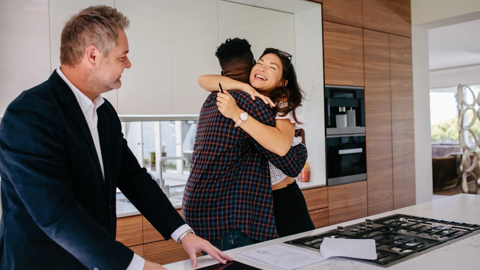 a couple hugging in a kitchen