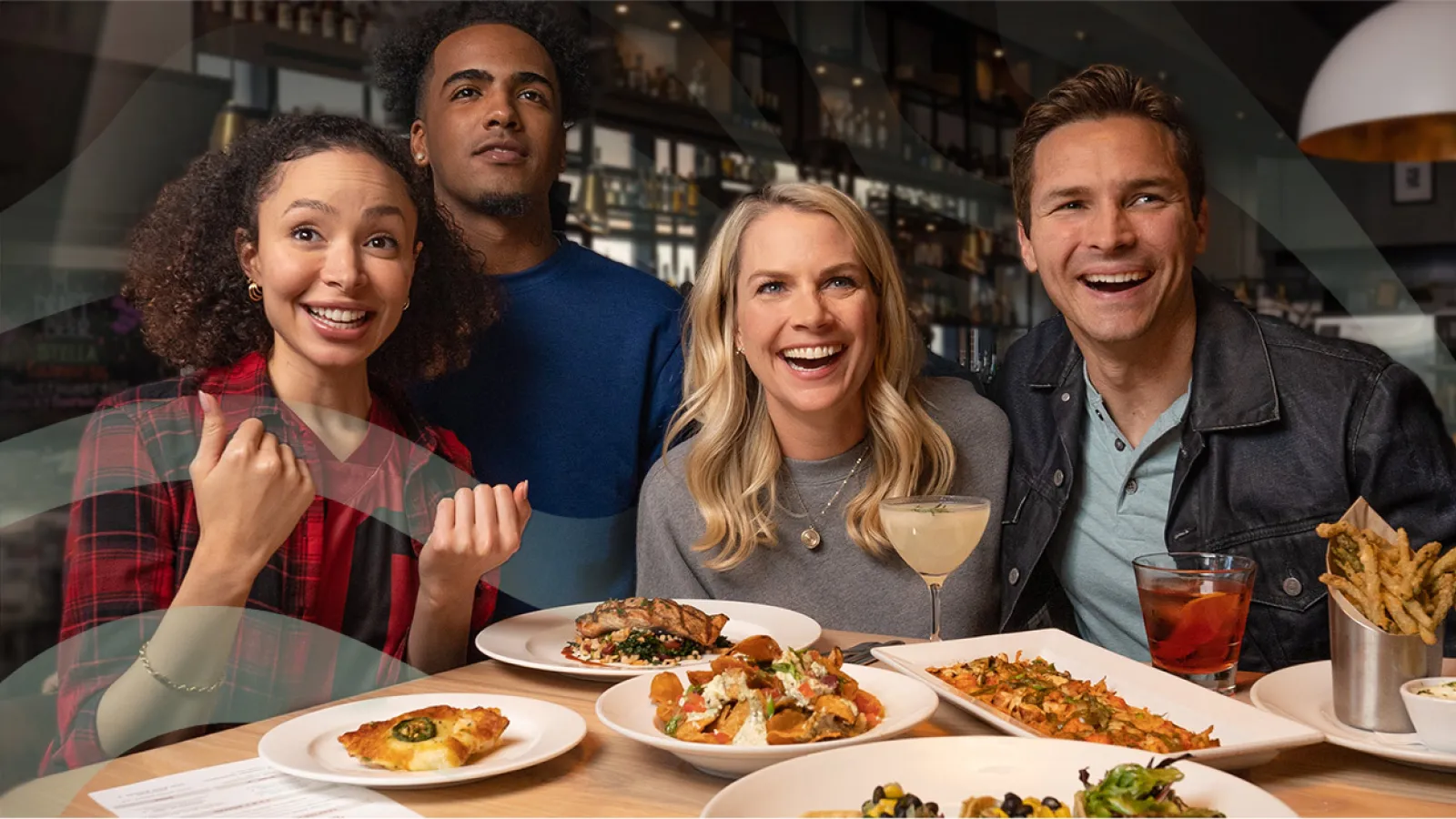 Rocky Myers, Erin Ross et al. sitting at a table with food