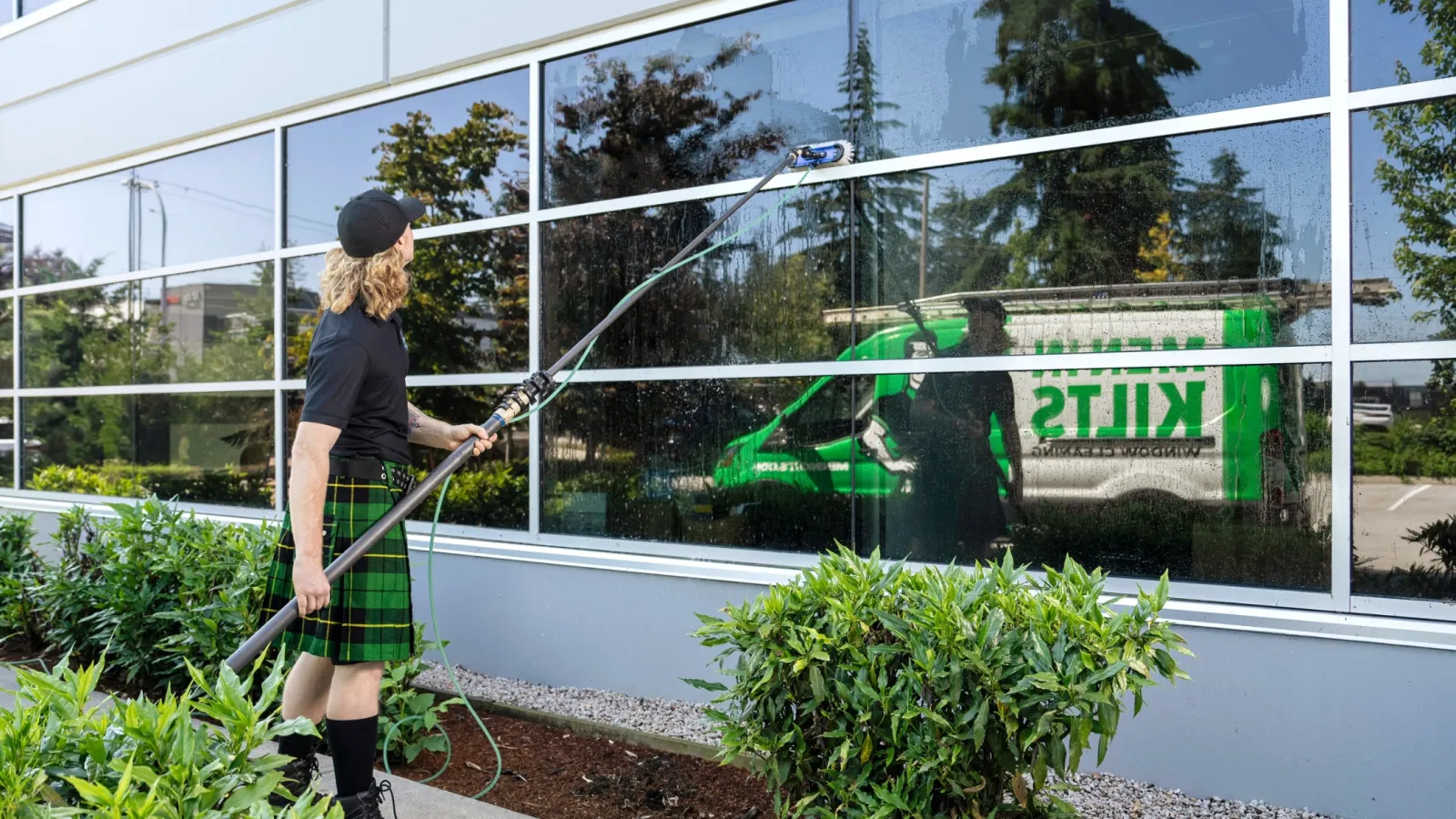 a person on a ladder painting a window