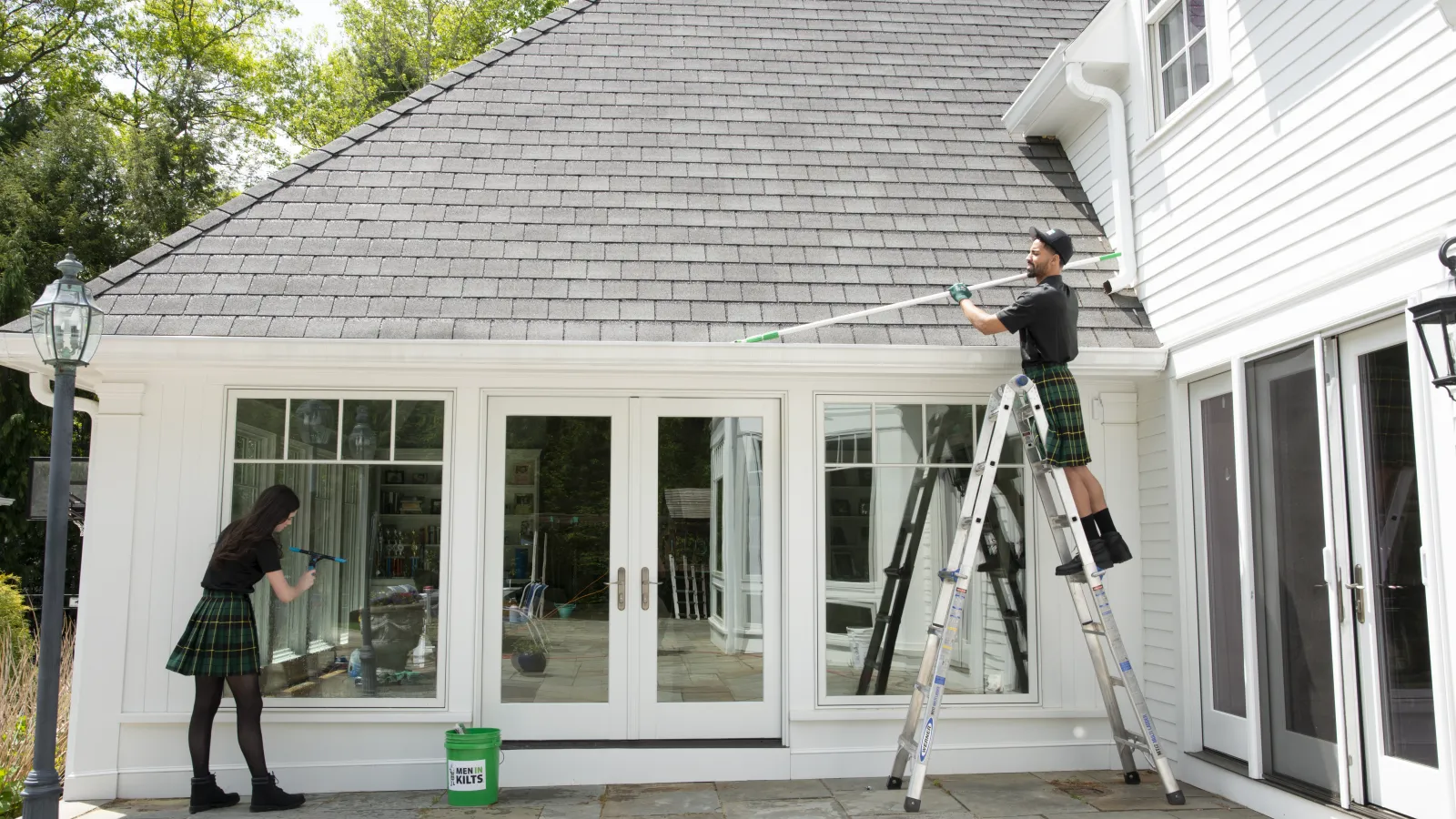 a person on a ladder painting a house