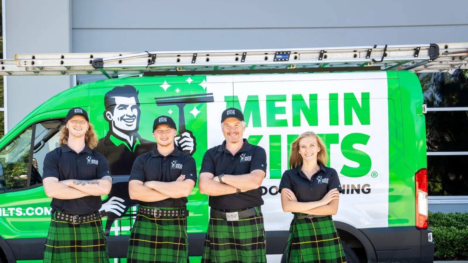 a group of people in kilts standing in front of a green van