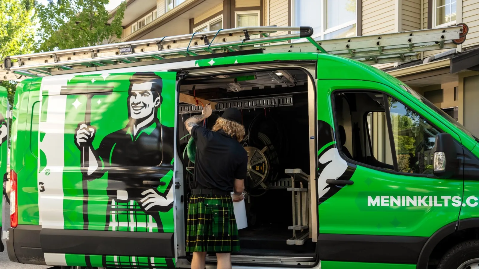 a person standing in front of a green van