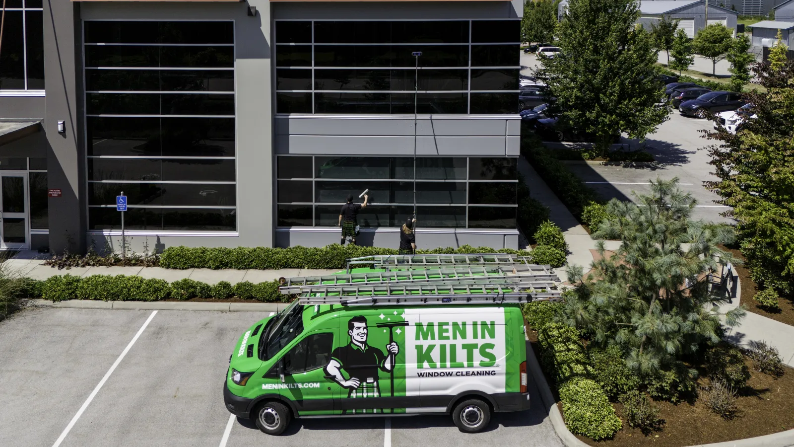 a green van with a cartoon character on it in front of a building