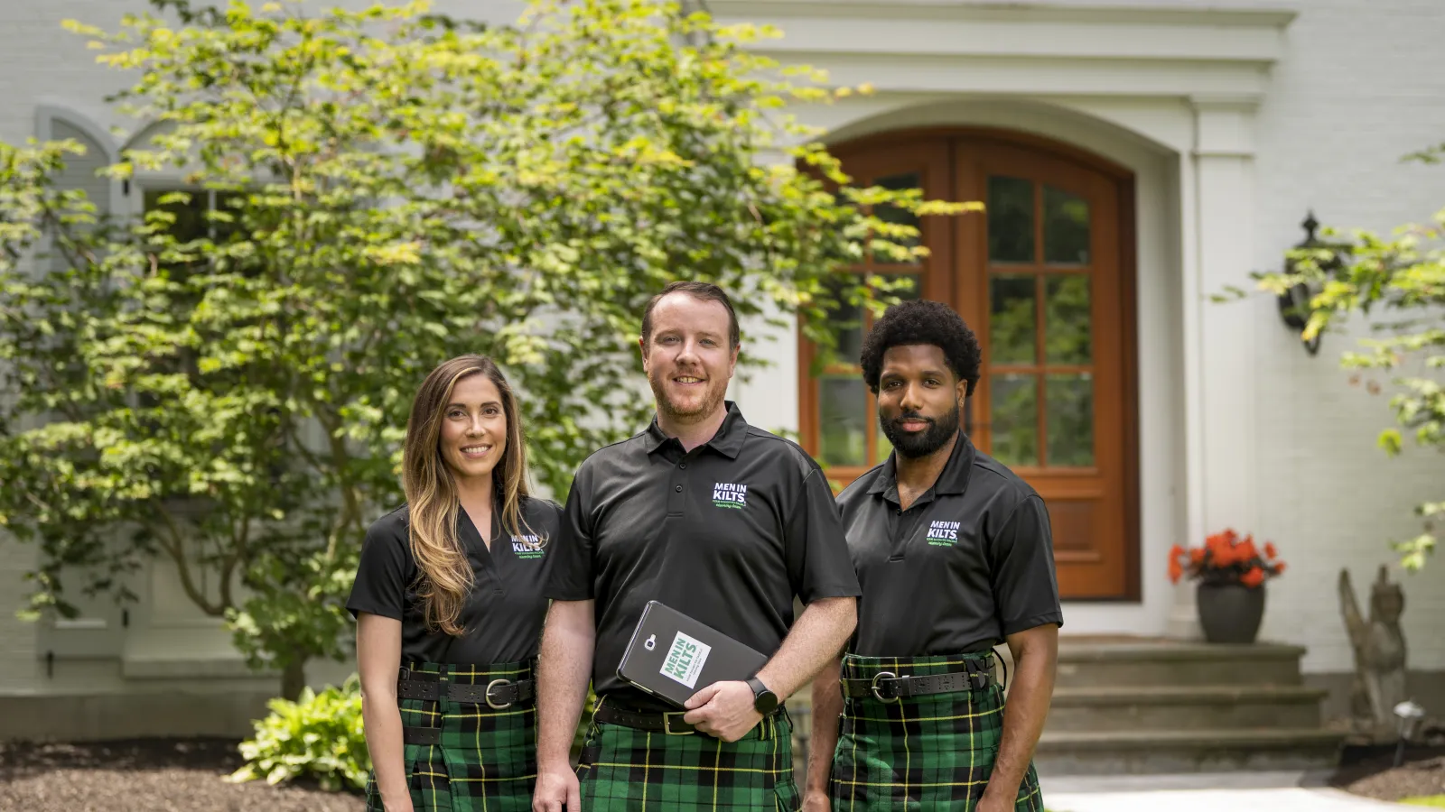 James Doyle et al. posing for a photo with a kilt