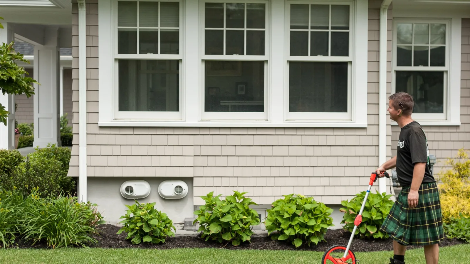 a person holding a red bicycle