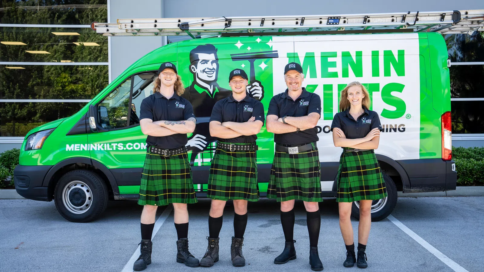 Four uniformed workers in kilts stand confidently in front of a branded service van.