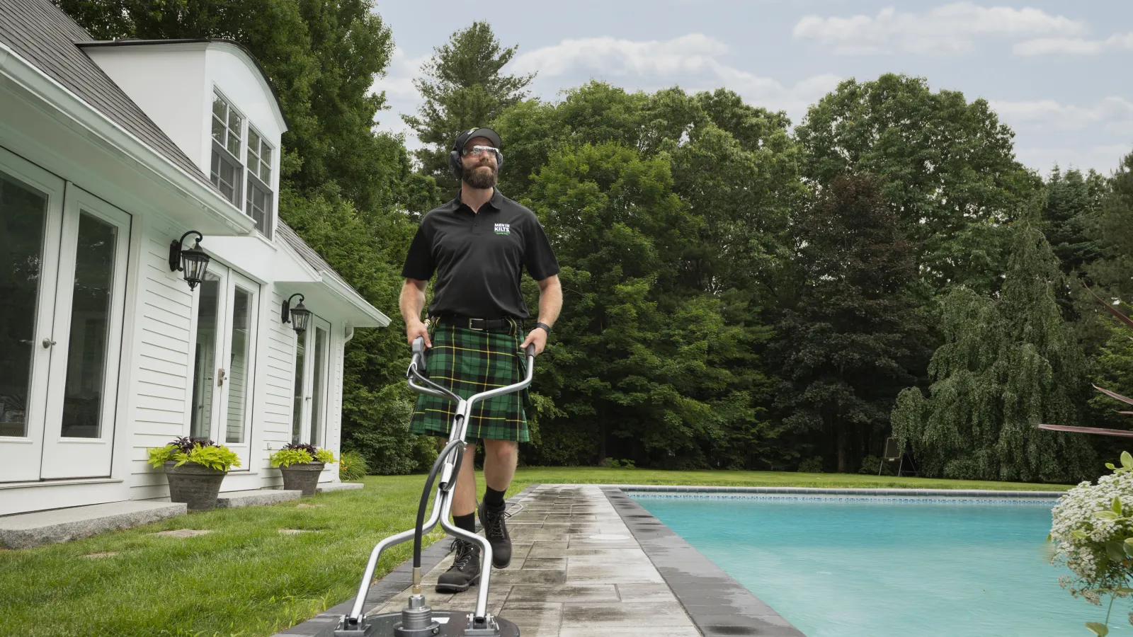 a man standing on a trampoline in front of a house