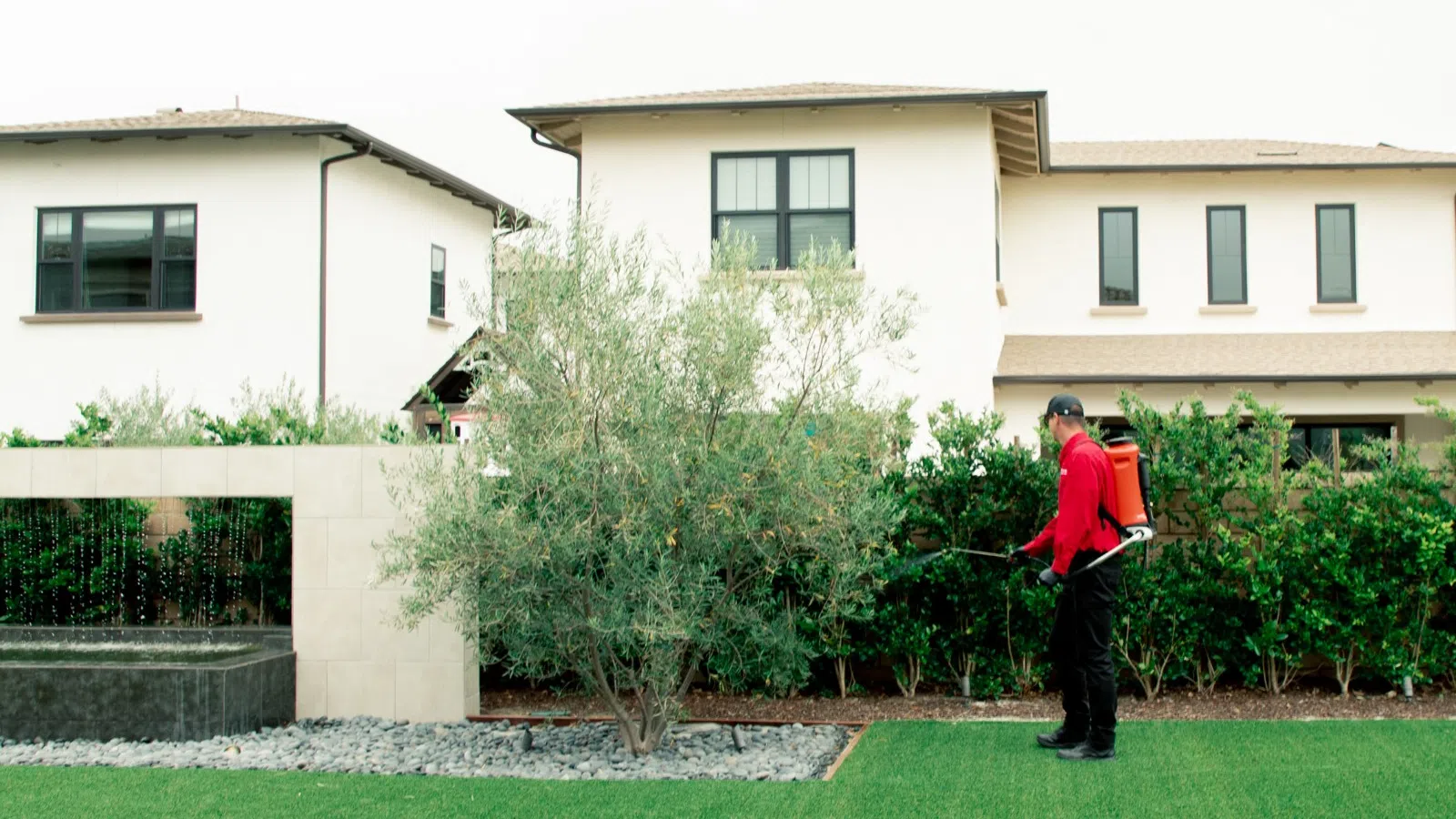 a man and a woman standing in a yard in front of a house