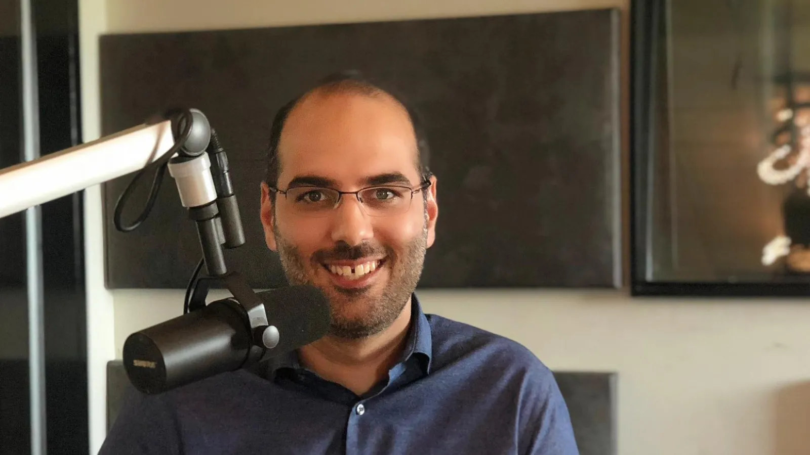 a man smiling with a microphone