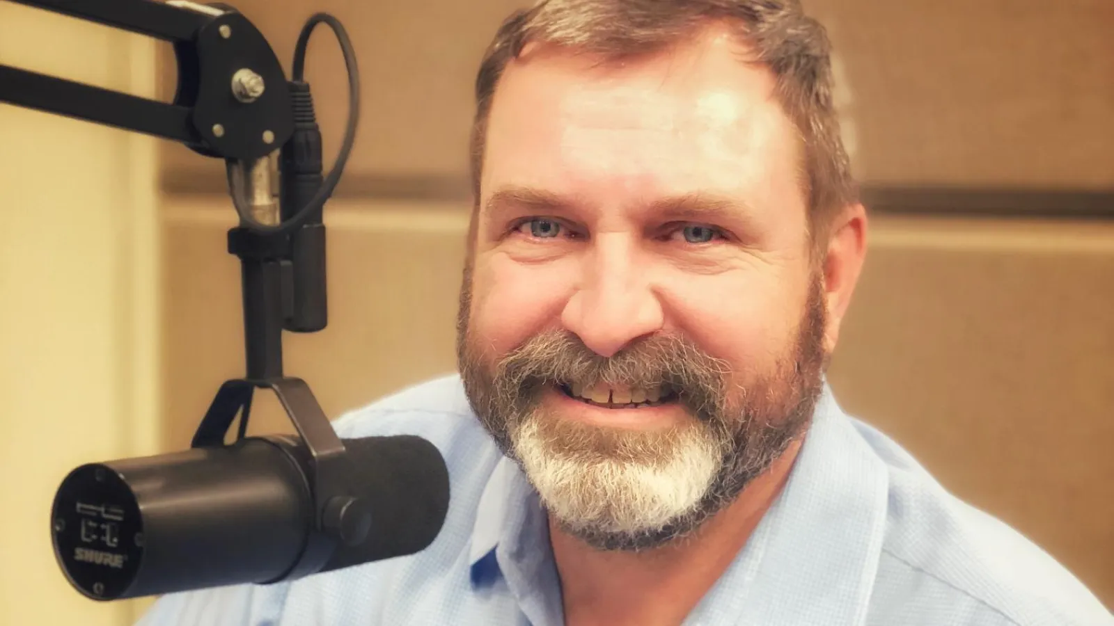 a man with a beard and a microphone on his head