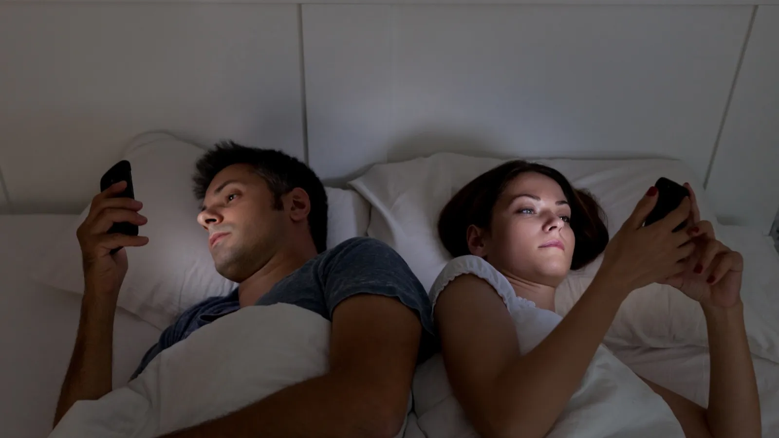 a man and woman lying in bed