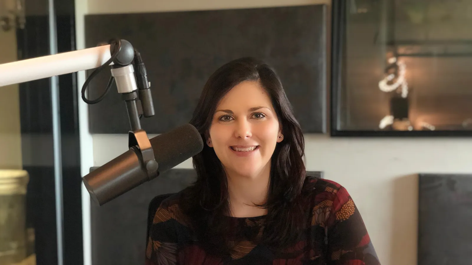 a woman sitting in front of a microphone