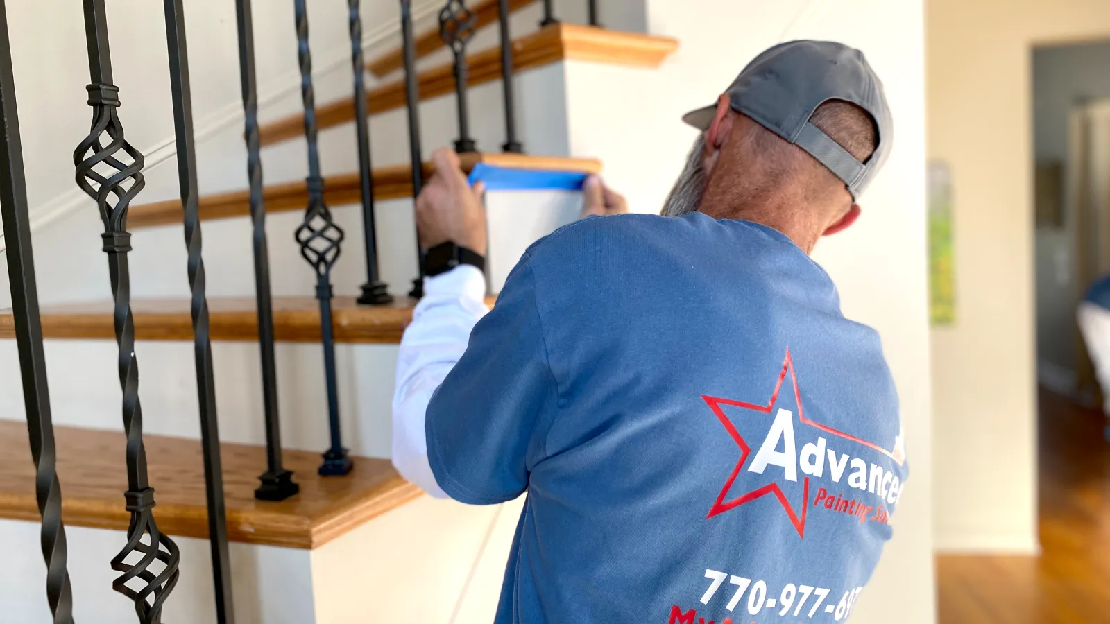 a man painting a staircase