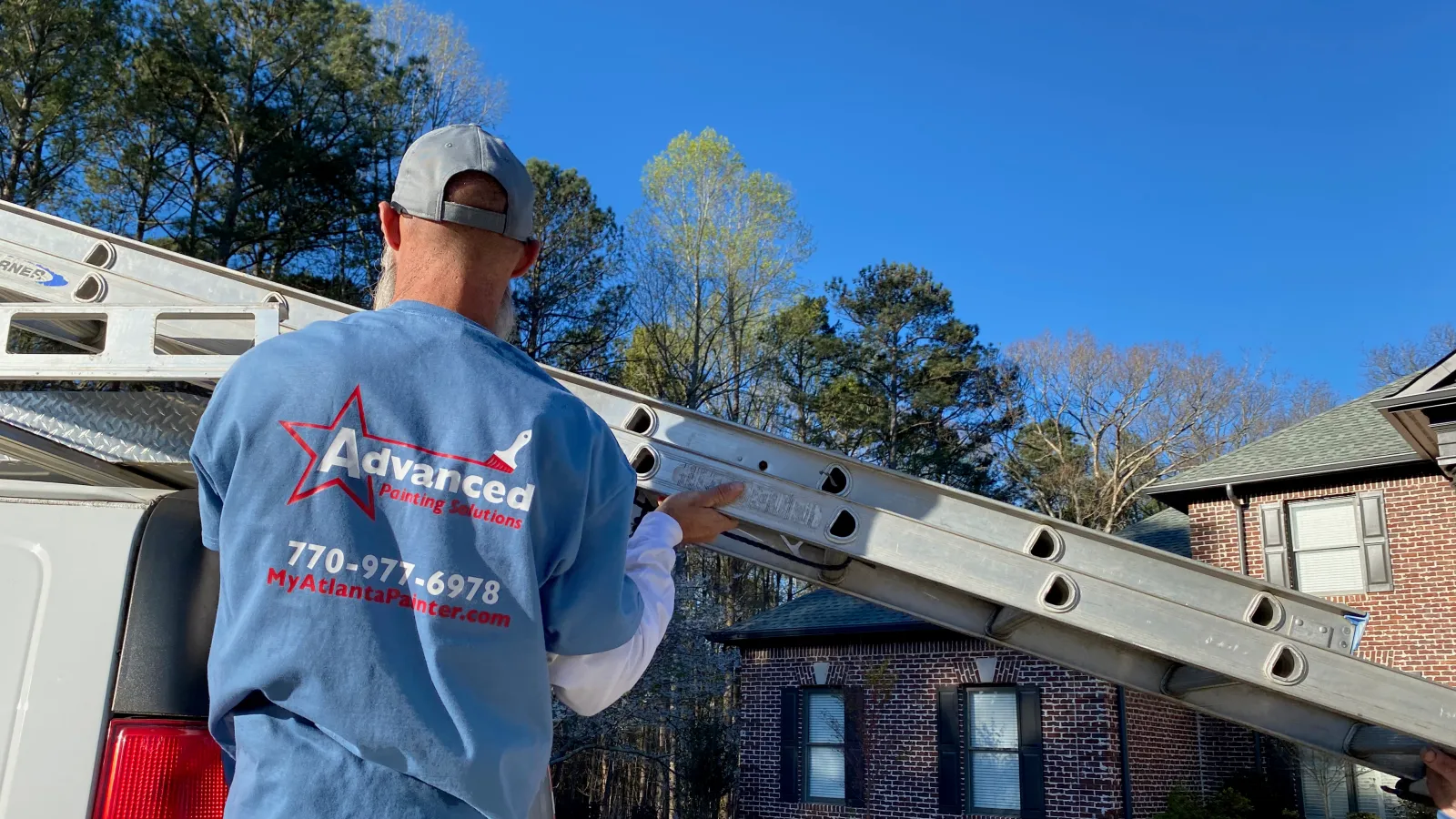 a man holding a large ladder