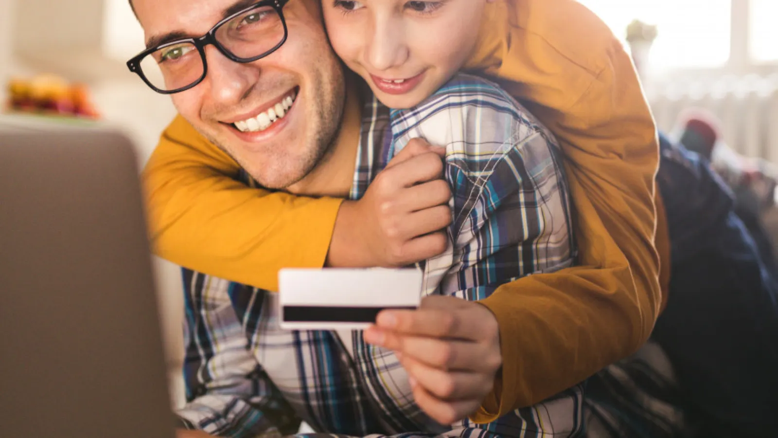 a man and a boy looking at a cell phone