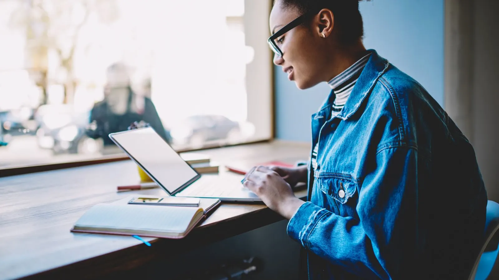 a man sitting at a desk looking at a tablet