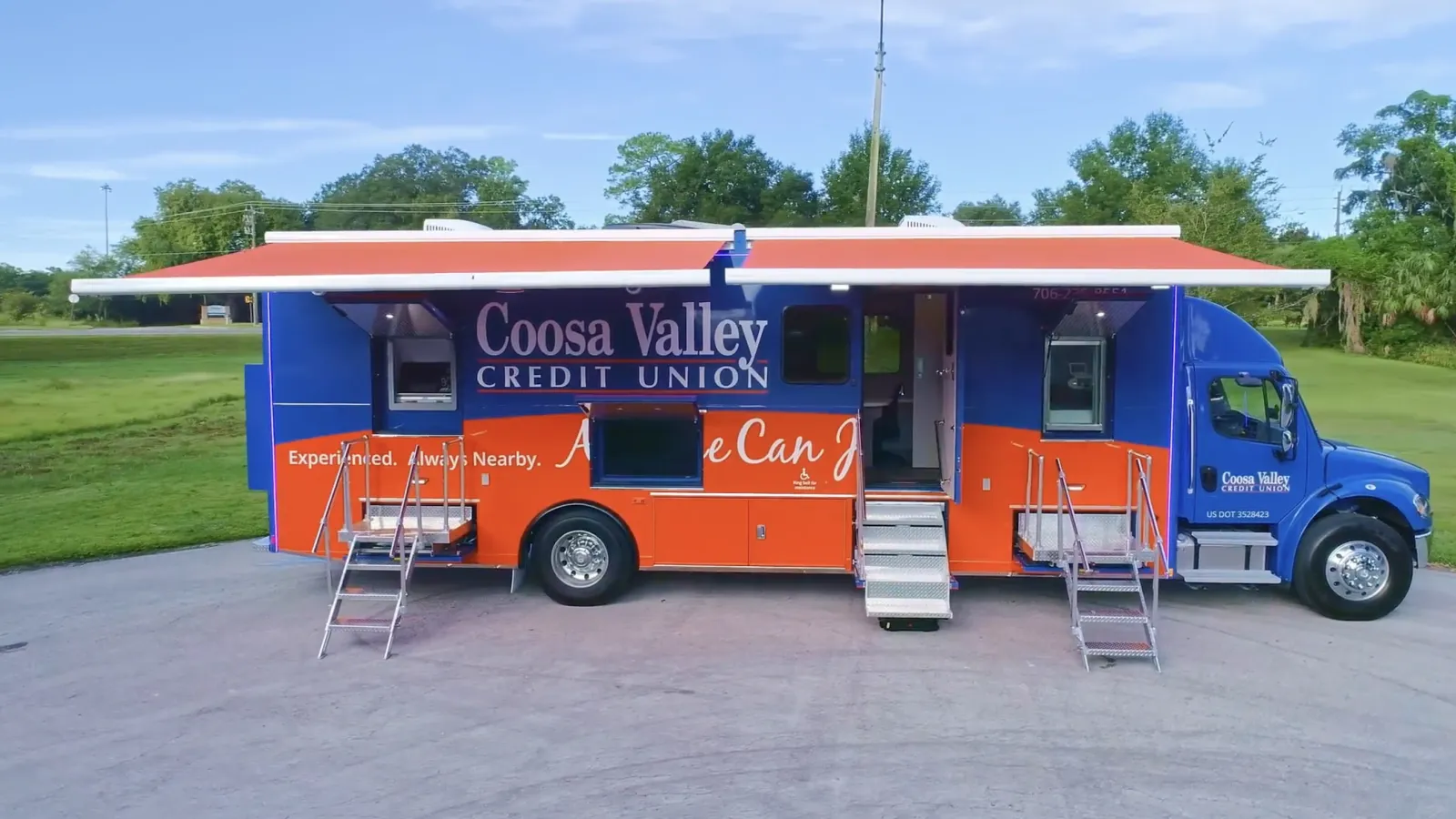 Coosa Valley Credit Union mobile branch truck with stairs and extended awnings in a parking lot.