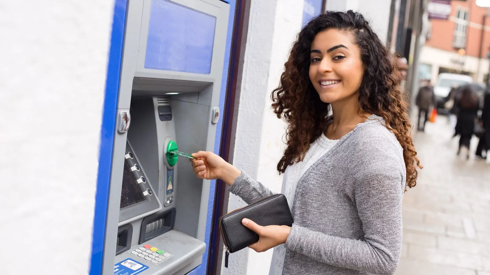 a woman holding a credit card and a credit card