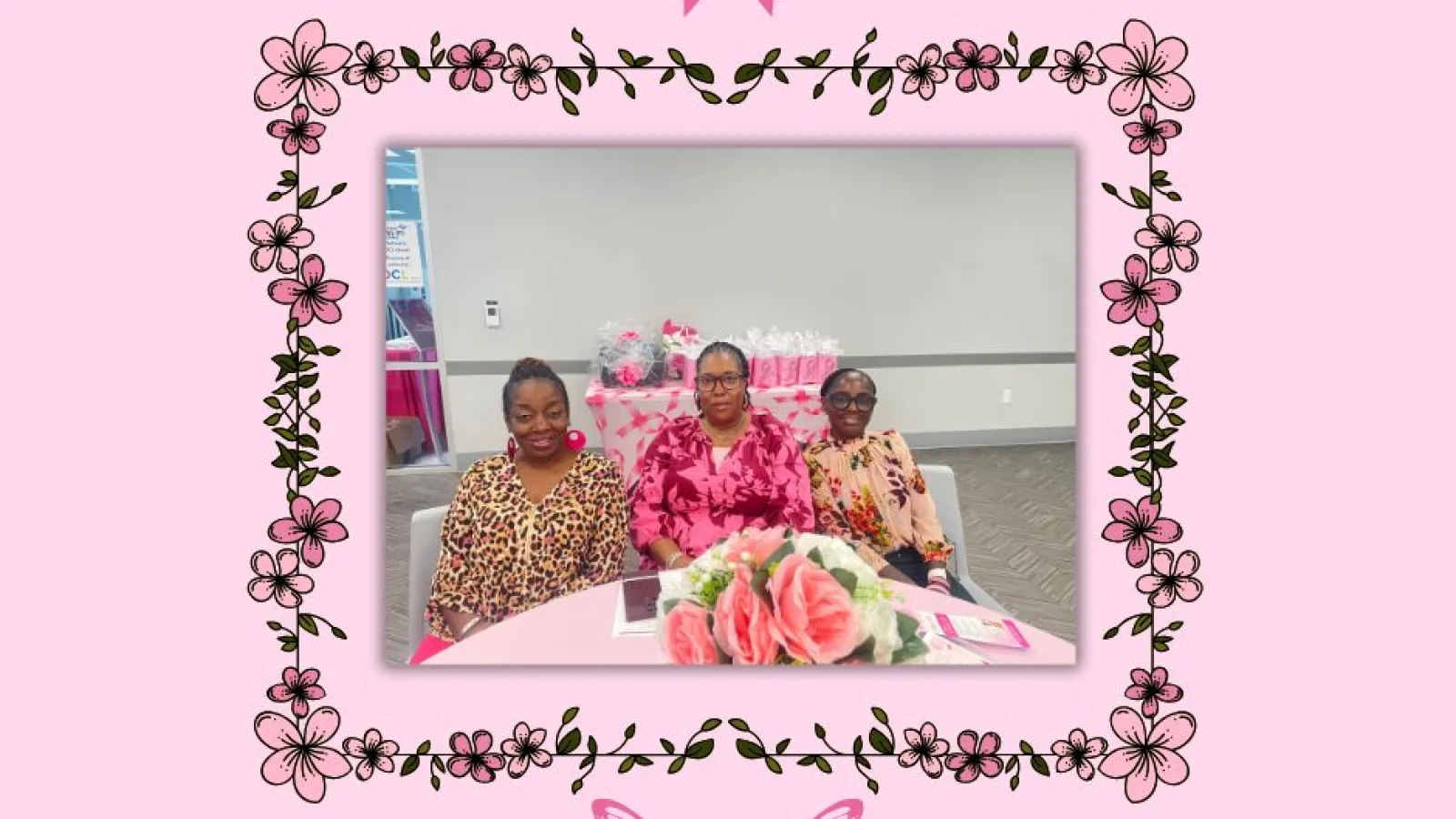 Three women at a pink breast cancer awareness event with floral and ribbon butterfly decorations