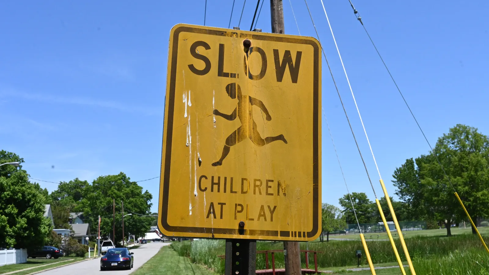 a yellow sign on a post