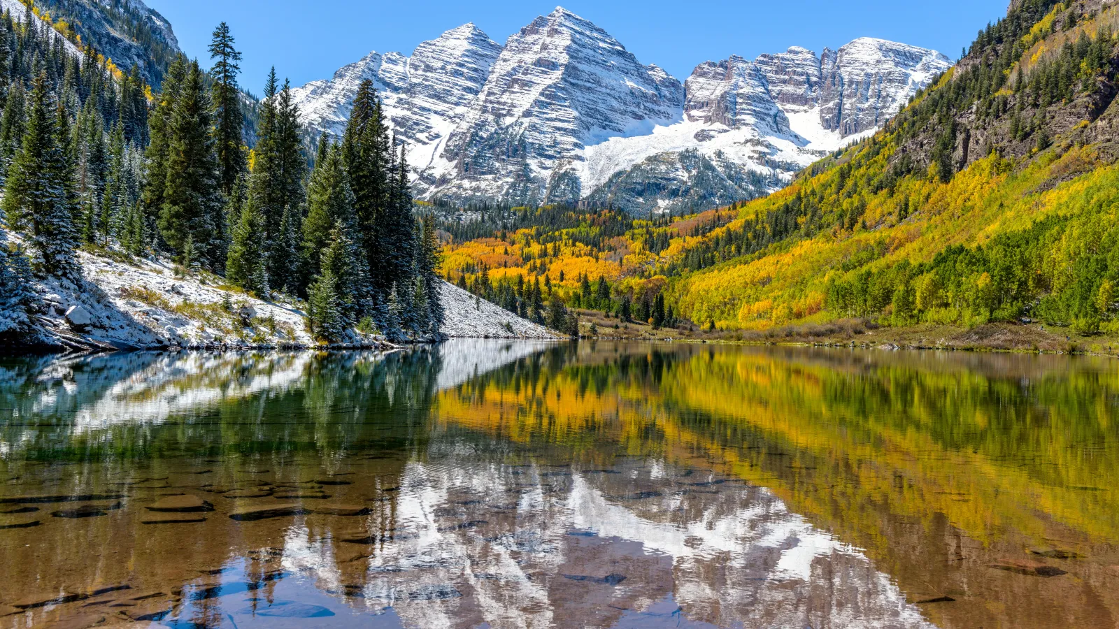 Maroon Bells surrounded by mountains and trees in Colorado