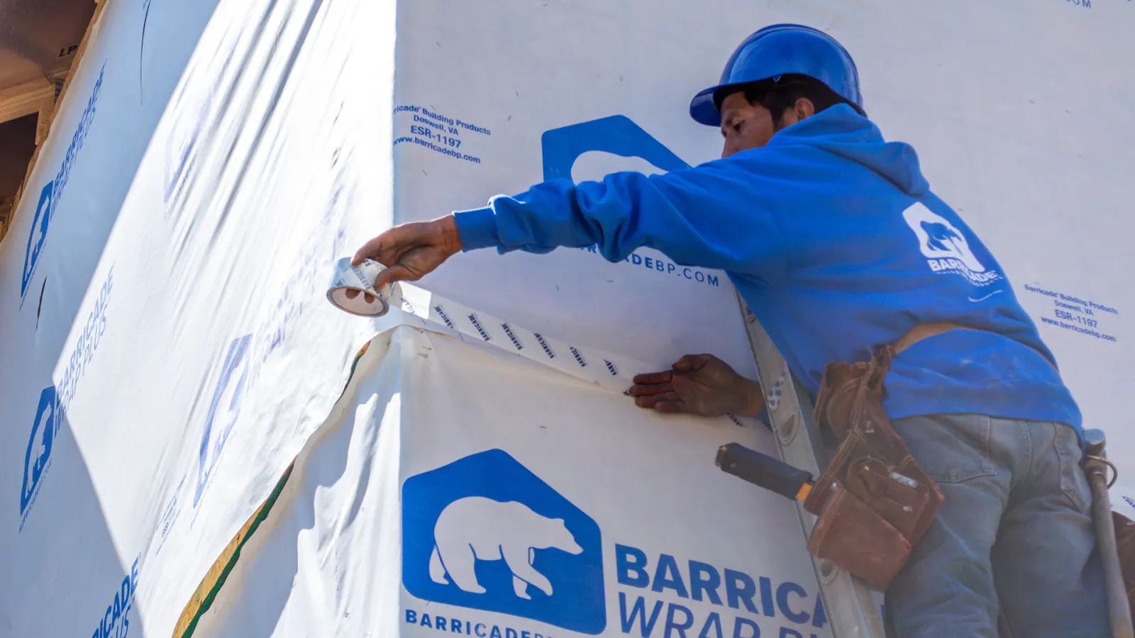 a man in a hard hat doing a siding wrap in Marietta, GA