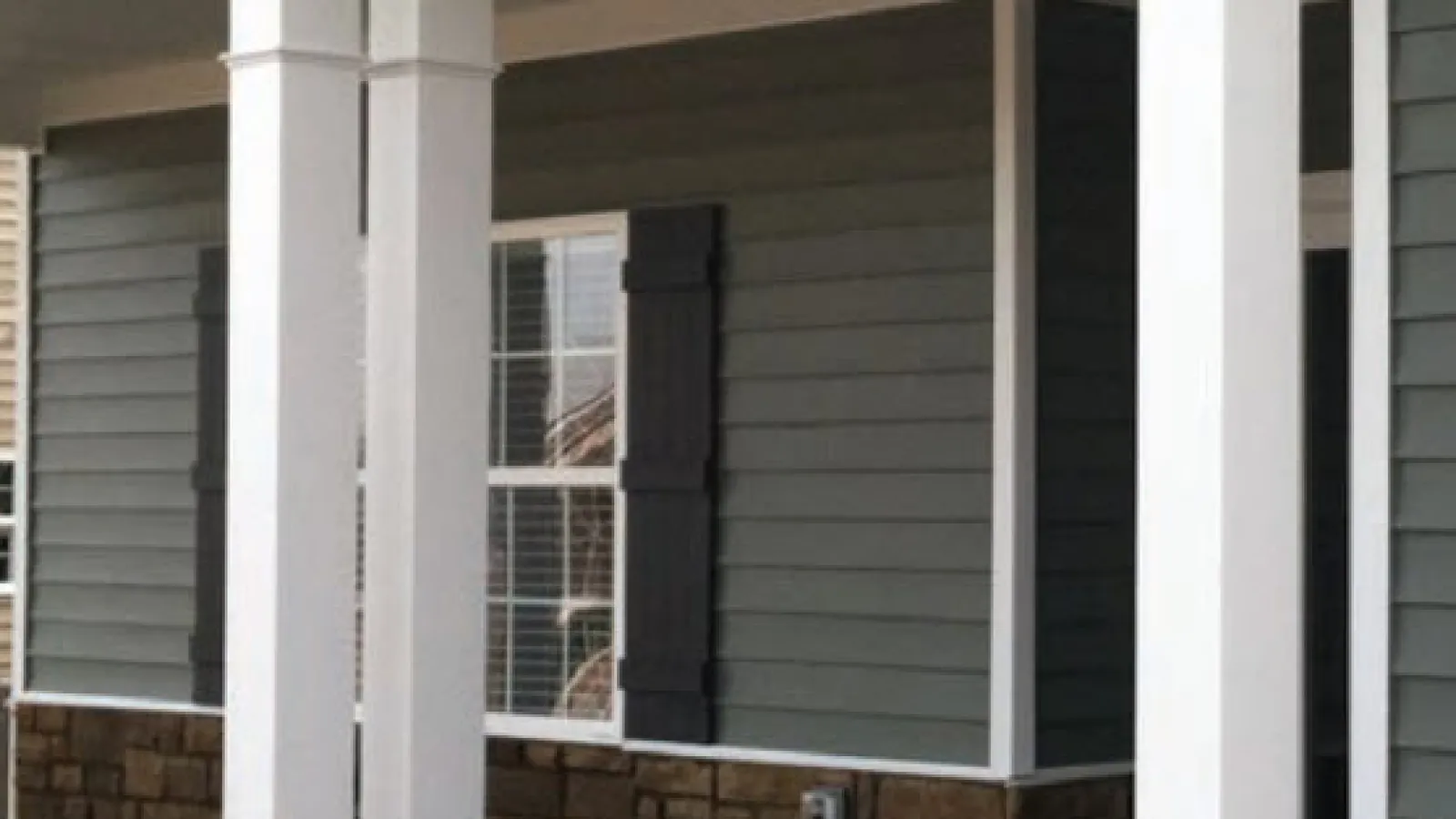 House with green siding and white pillars in Marietta, GA