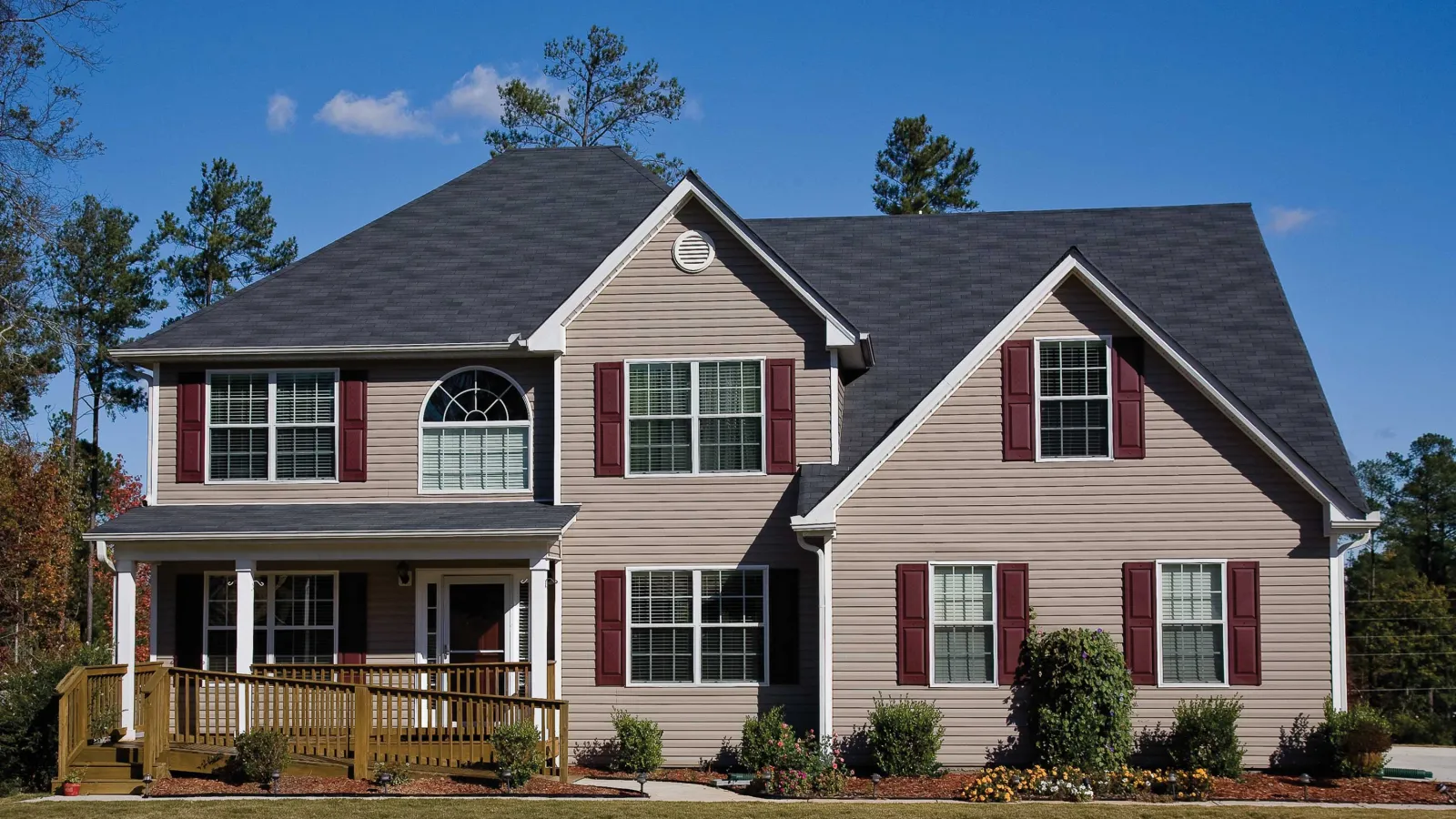 a house with black roof, red windows and siding in Marietta, GA