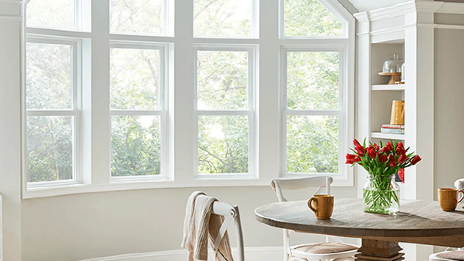 a room with a table, chairs and a large MI Windows in Marietta, GA