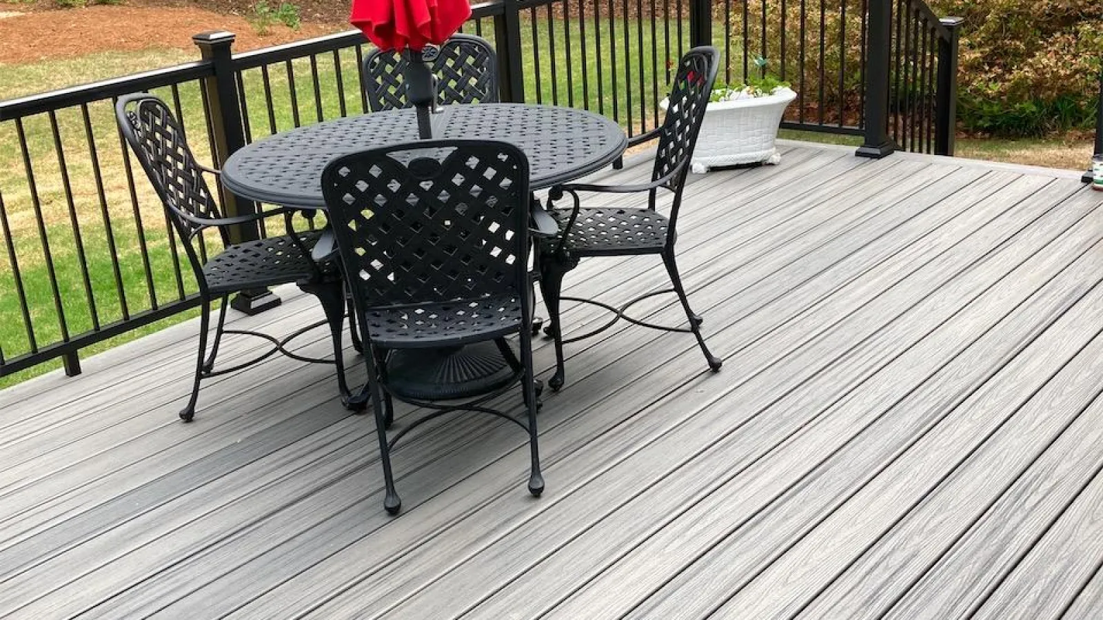 a deck with a table and chairs on it