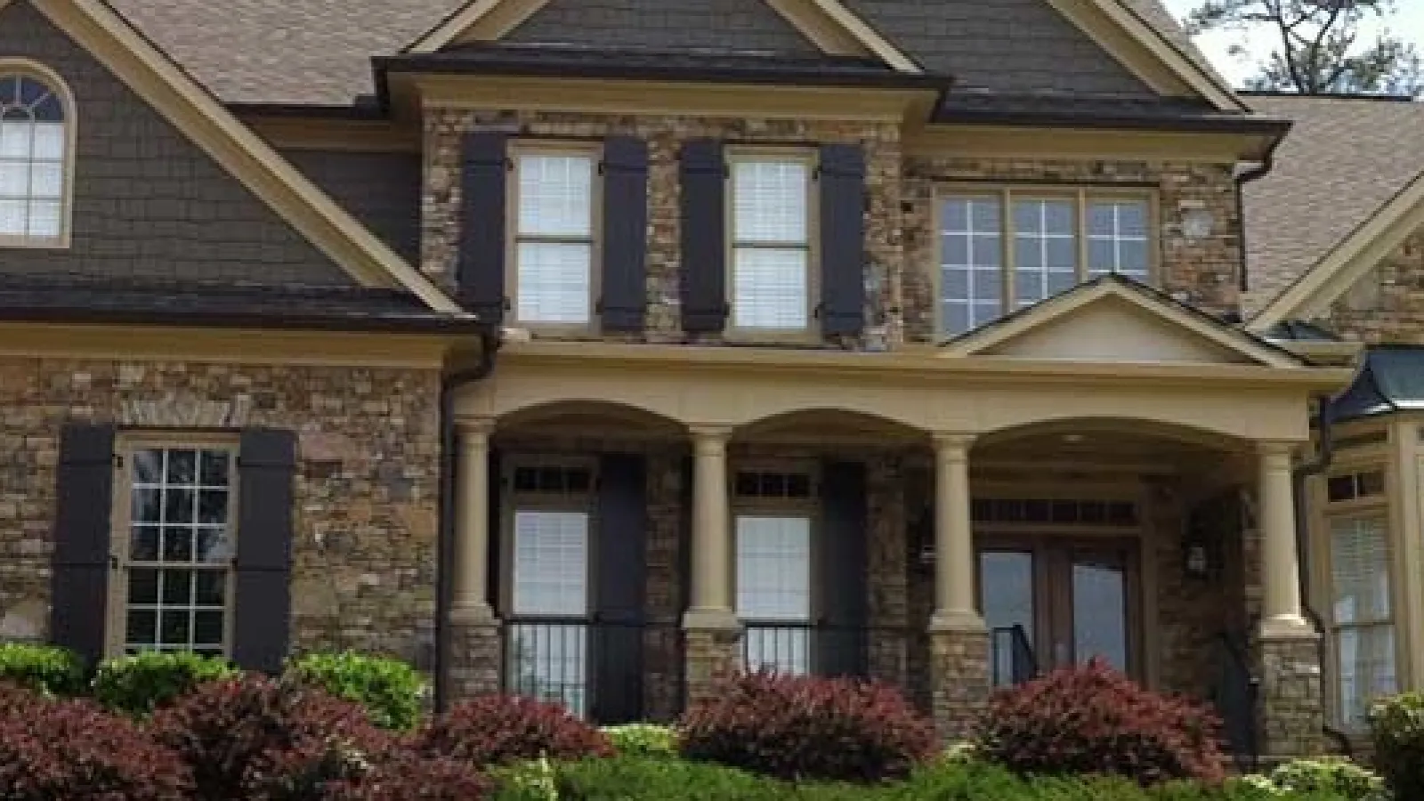 A house with brown rood and a brick style siding in Marietta, GA