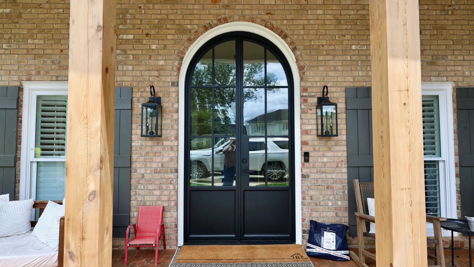 Door hardware on black arched double entry door by the door installation experts at NG Windows