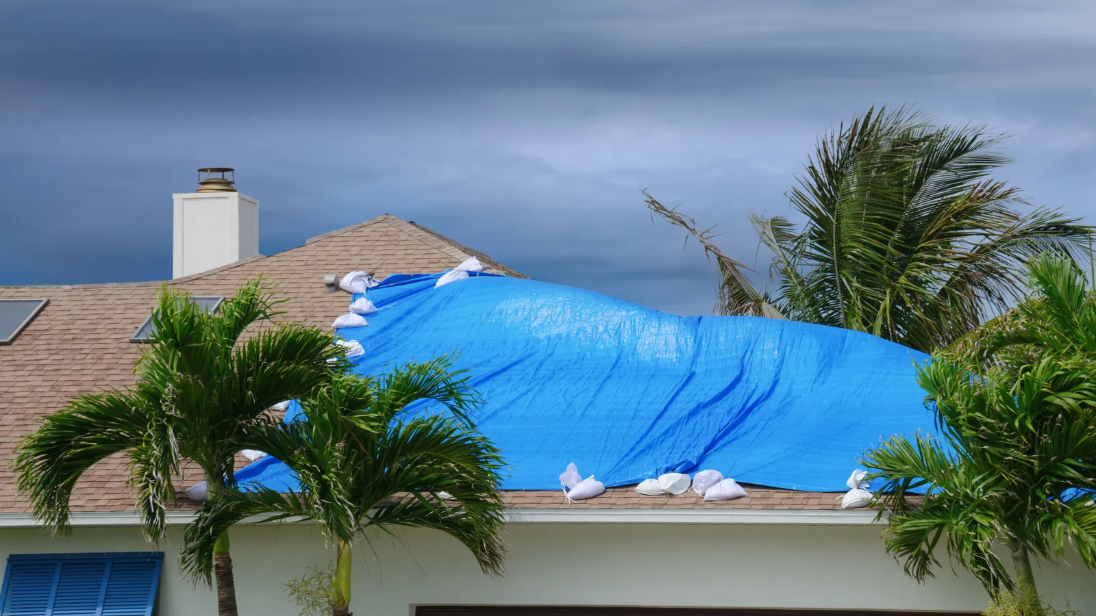 tarp protecting a roof from leaks