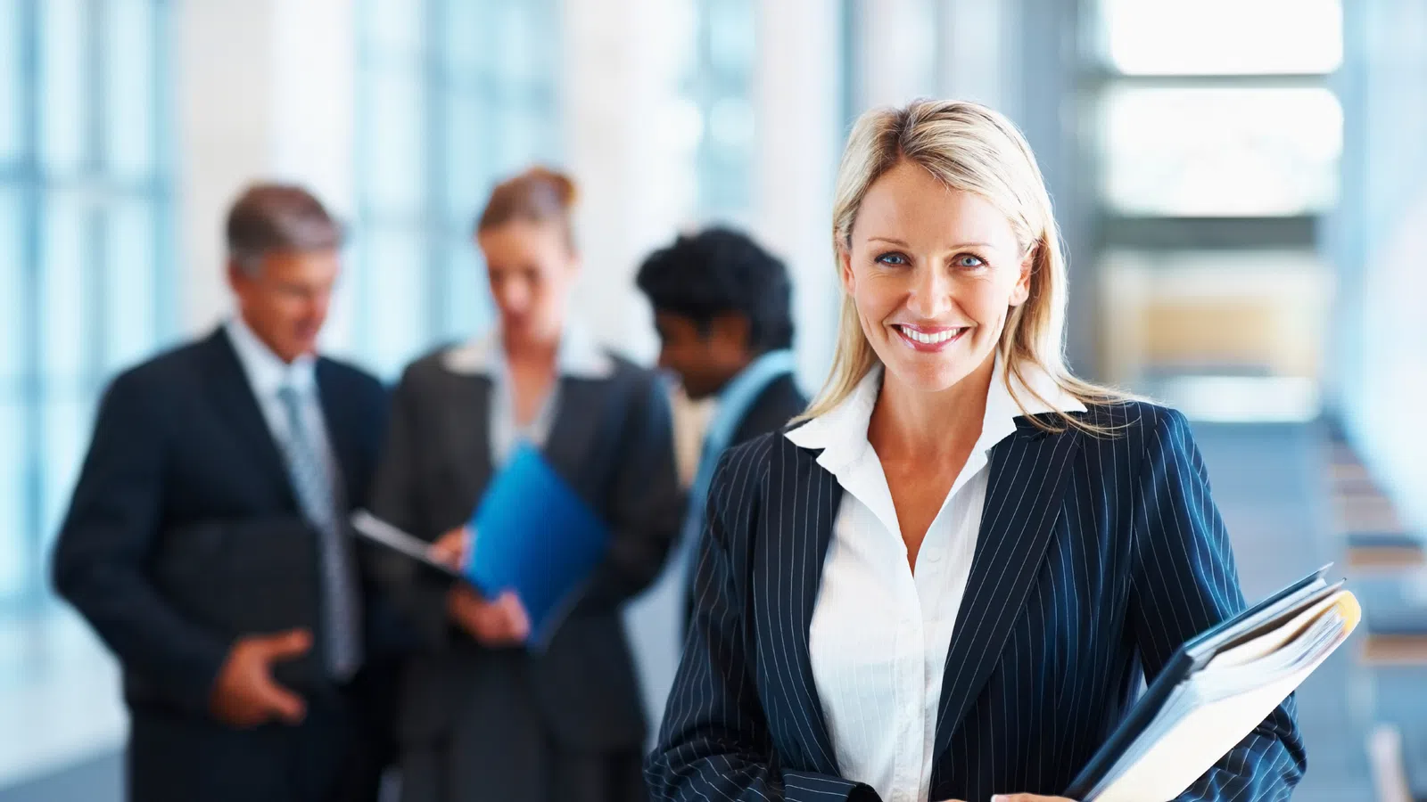 Melanie Bright holding a book - OAKS Advisory Group (Executive talent)