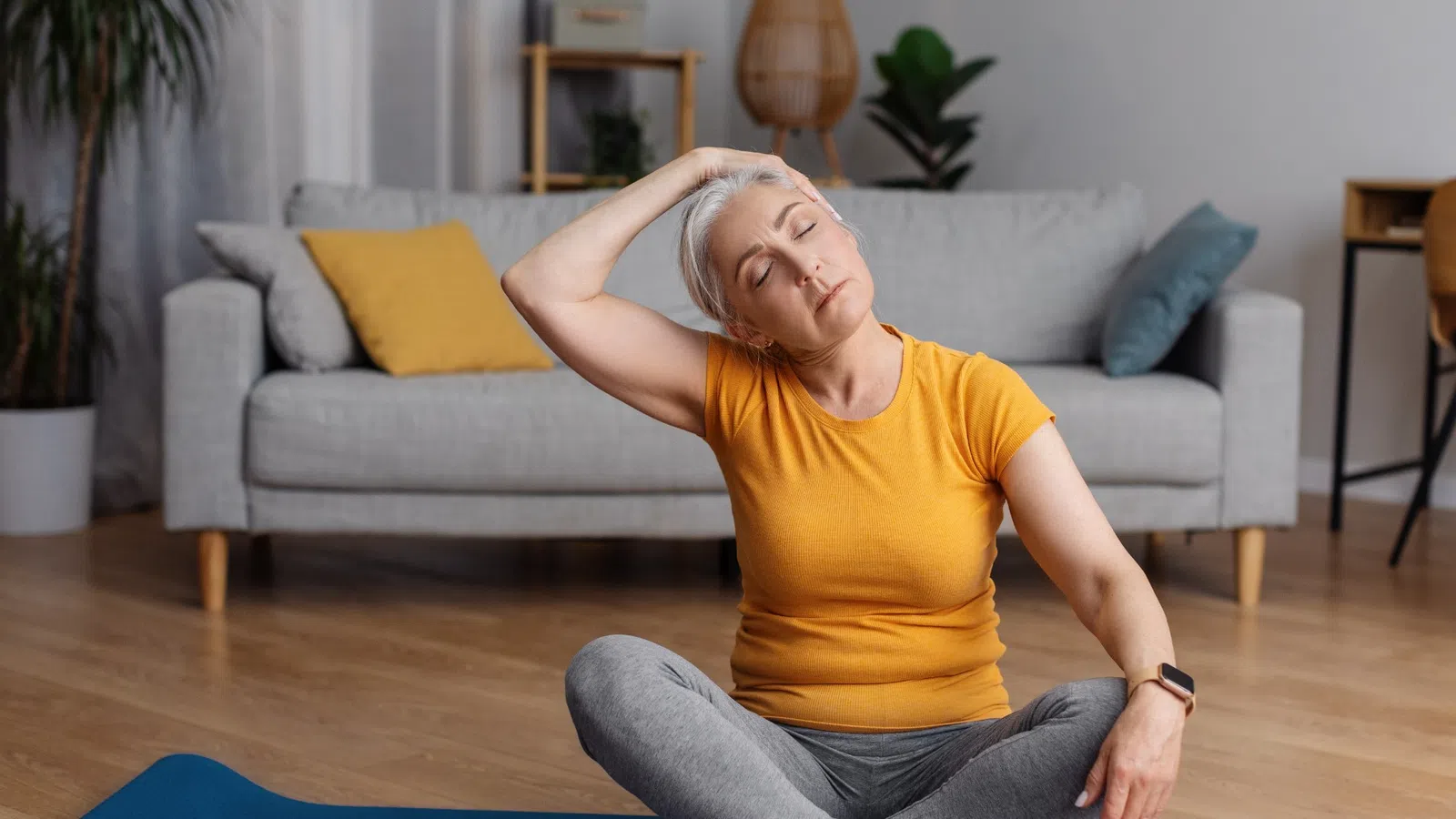 a woman sitting on a mat