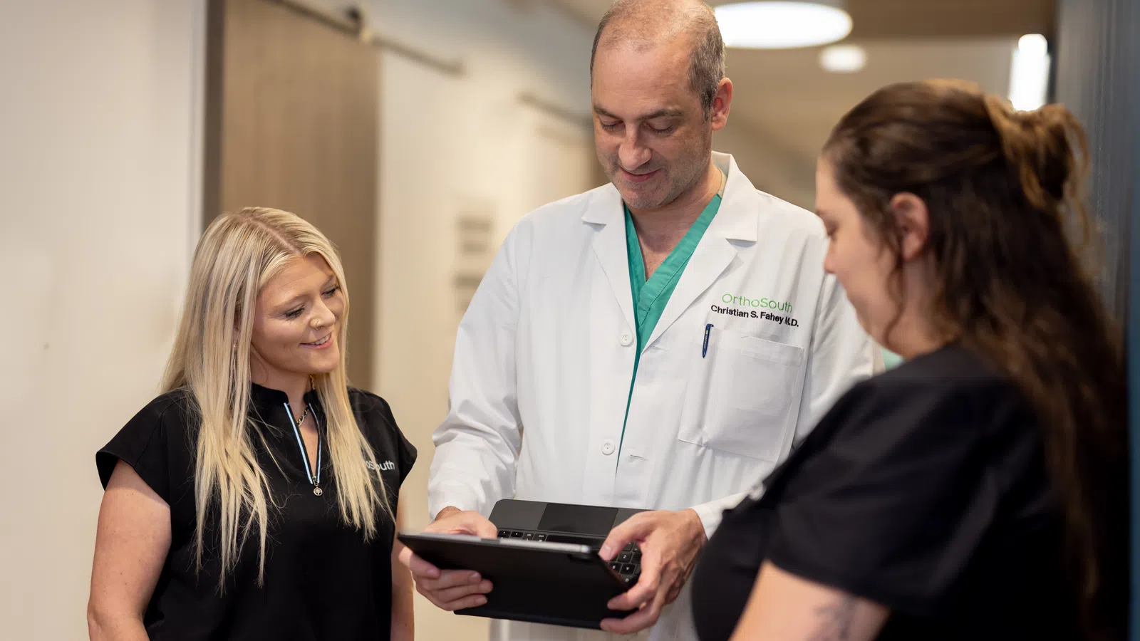 a doctor showing a person something on a tablet