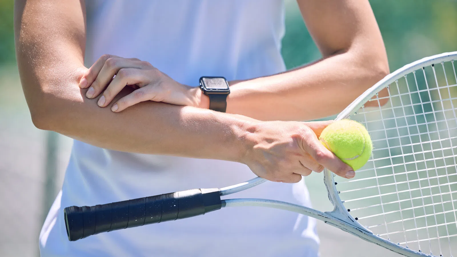 a person hitting a tennis ball with a racket