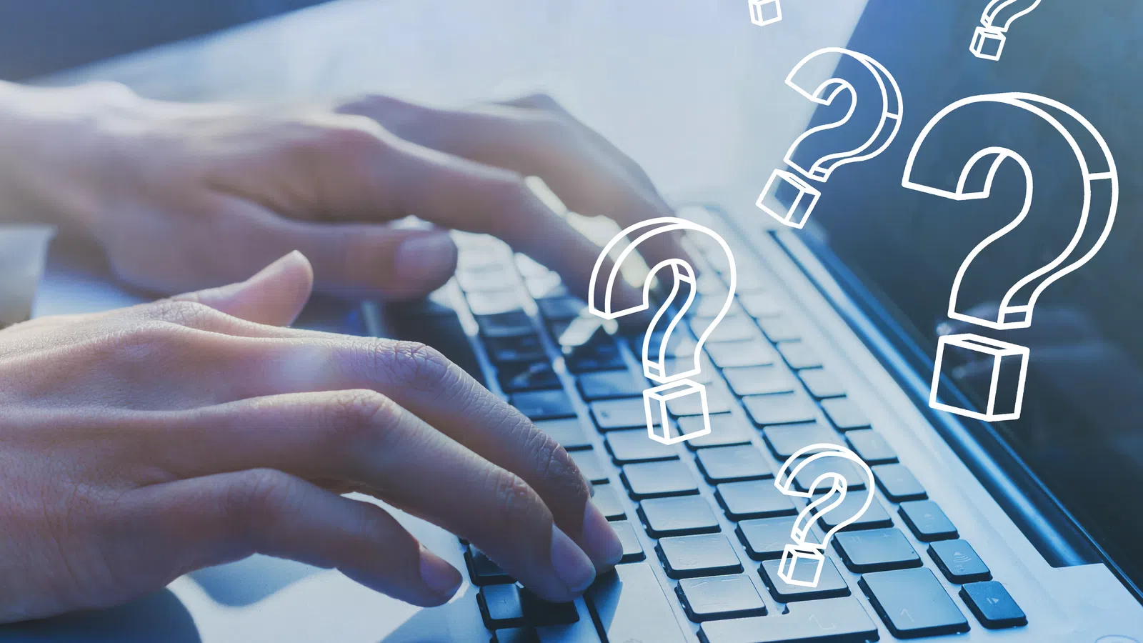 a hand on a laptop keyboard