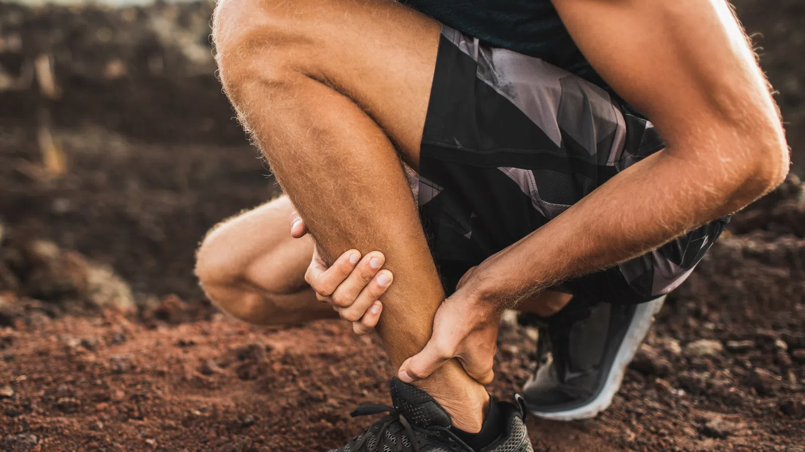 a man holding his ankle