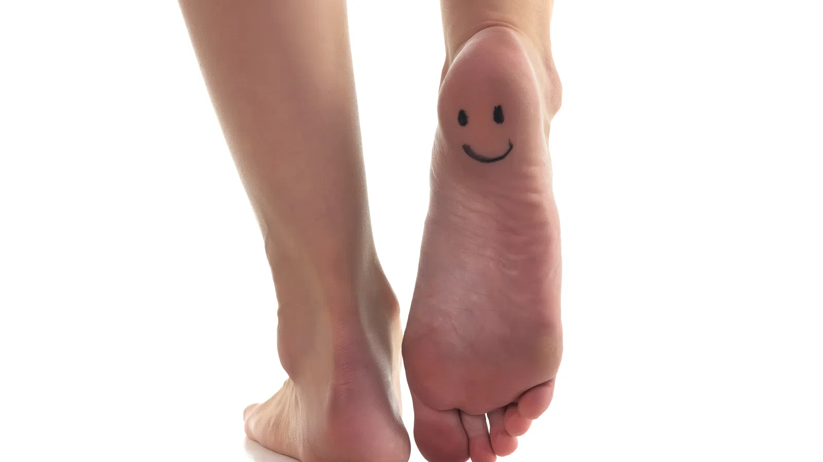 a pair of feet with a face drawn on them