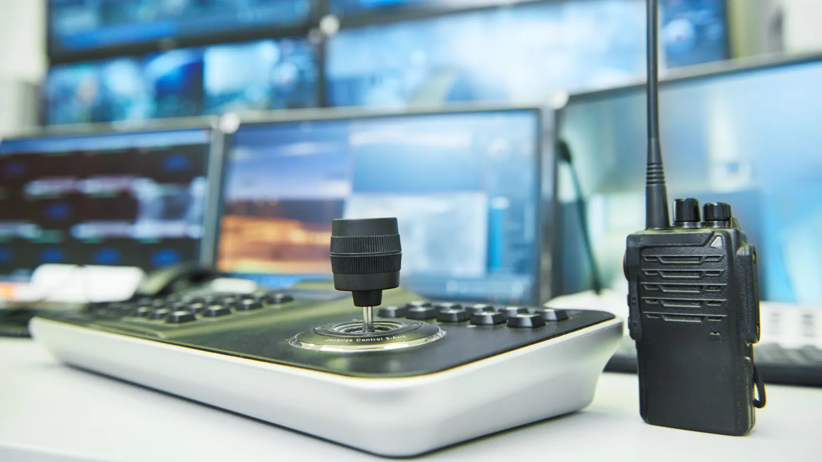 a black telephone on a white desk