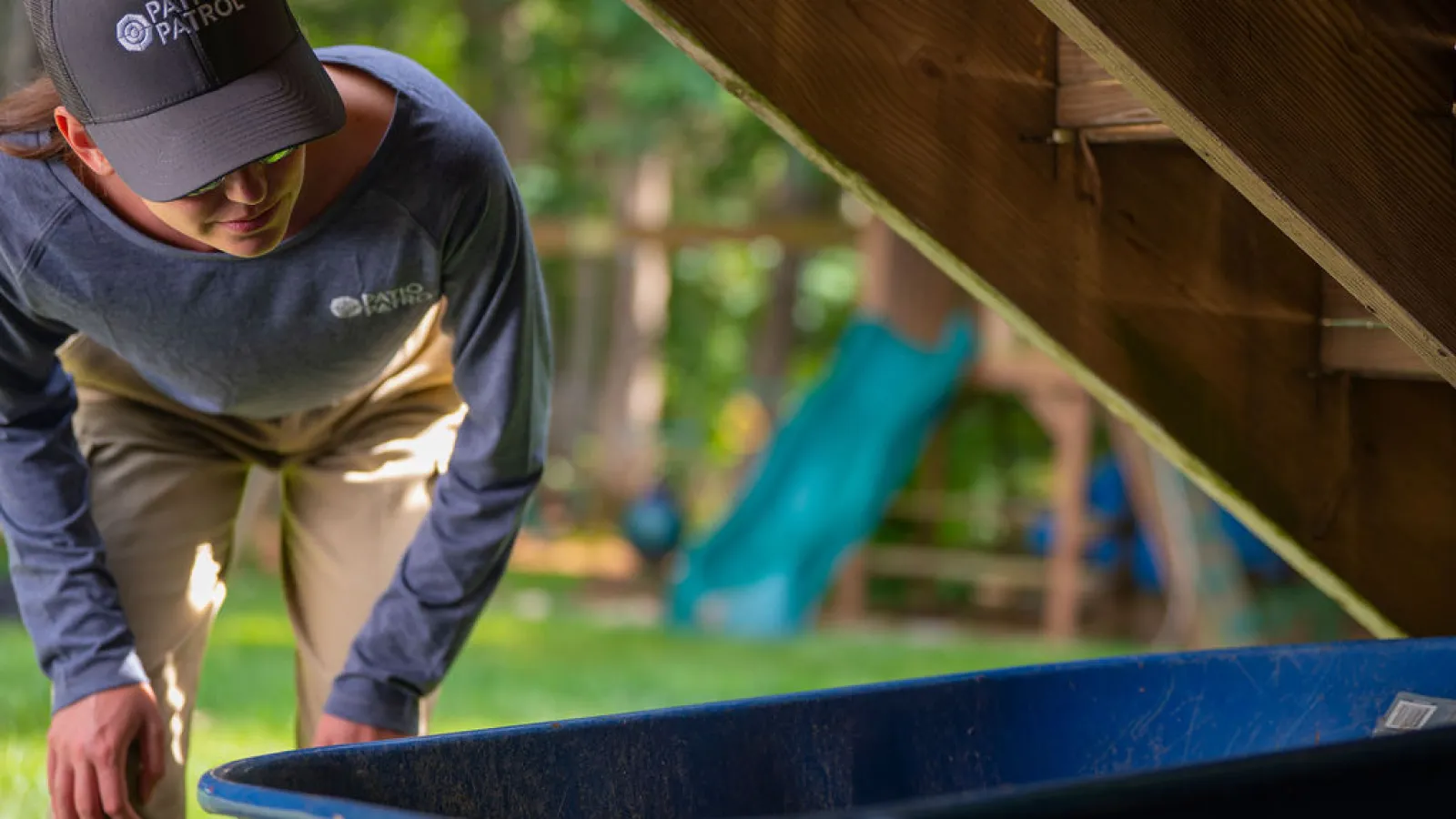 a person working on a blue piece of wood