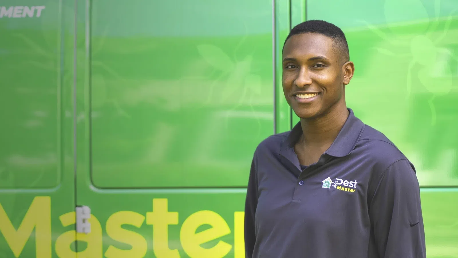 Sherlen Archibald smiling in front of a green screen