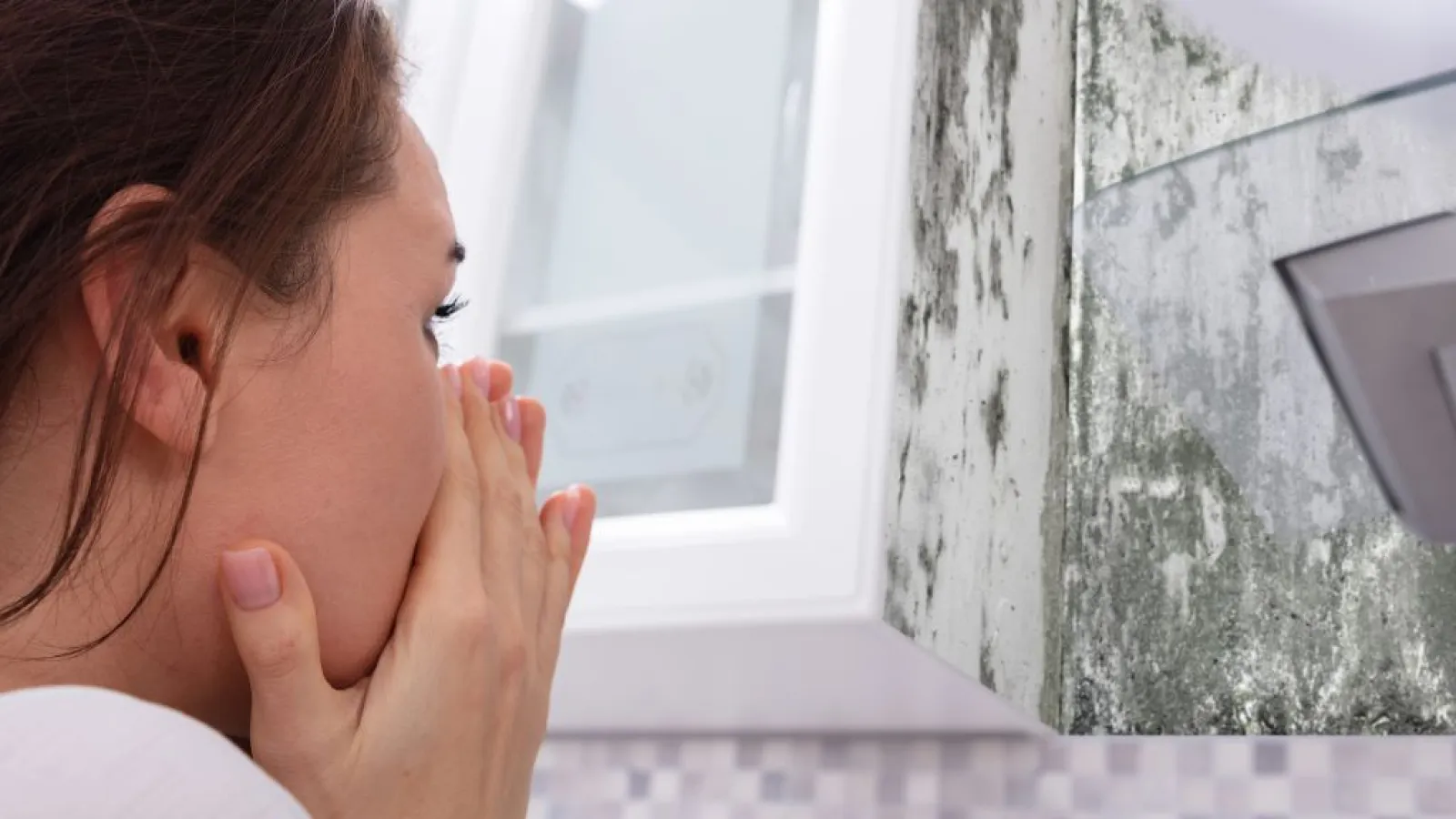 woman detecting mold before calling pestnation