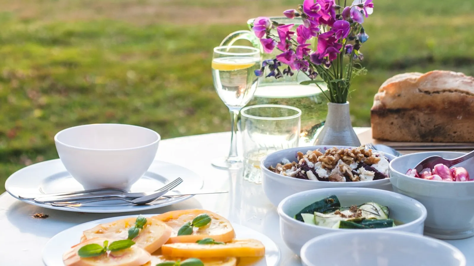 a table with plates and glasses of wine on it