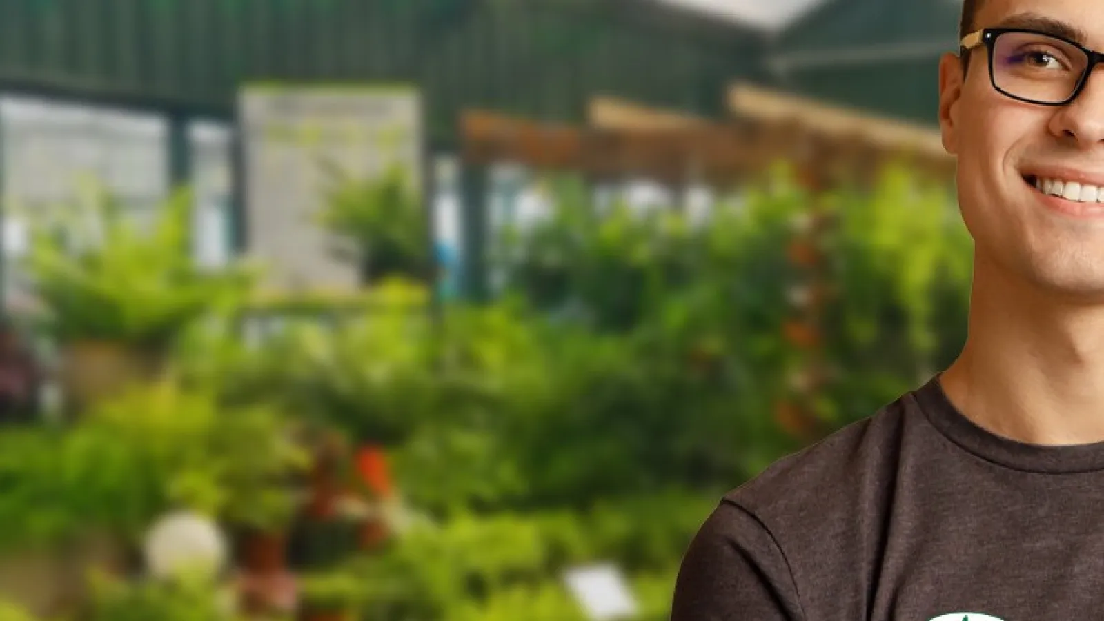 a man standing in a greenhouse