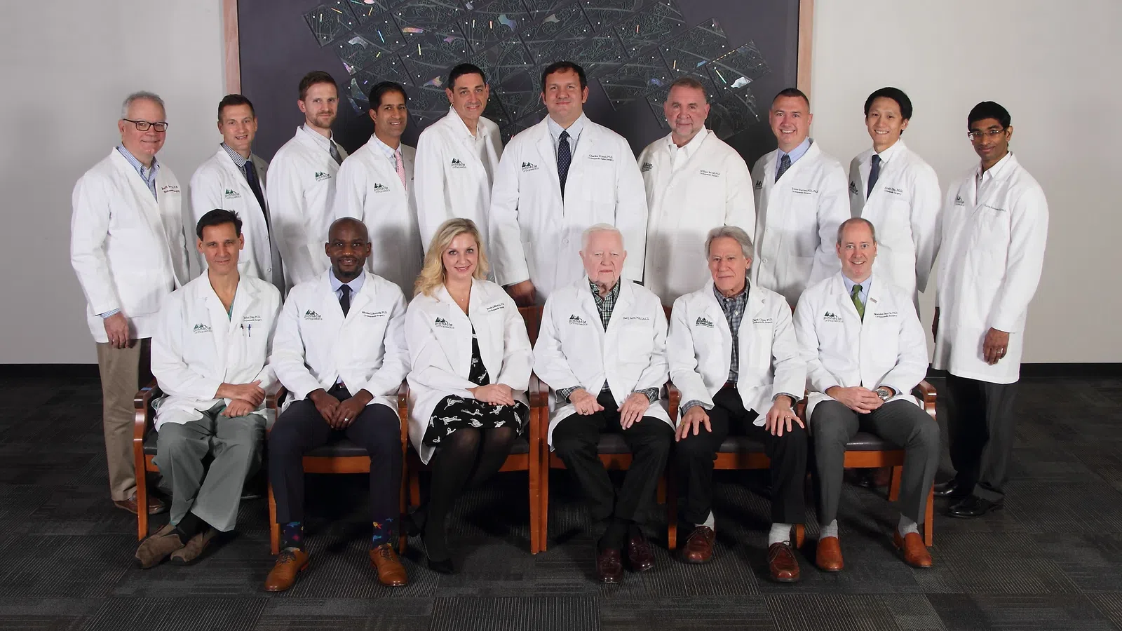 Group portrait of diverse medical professionals in white lab coats posing together indoors