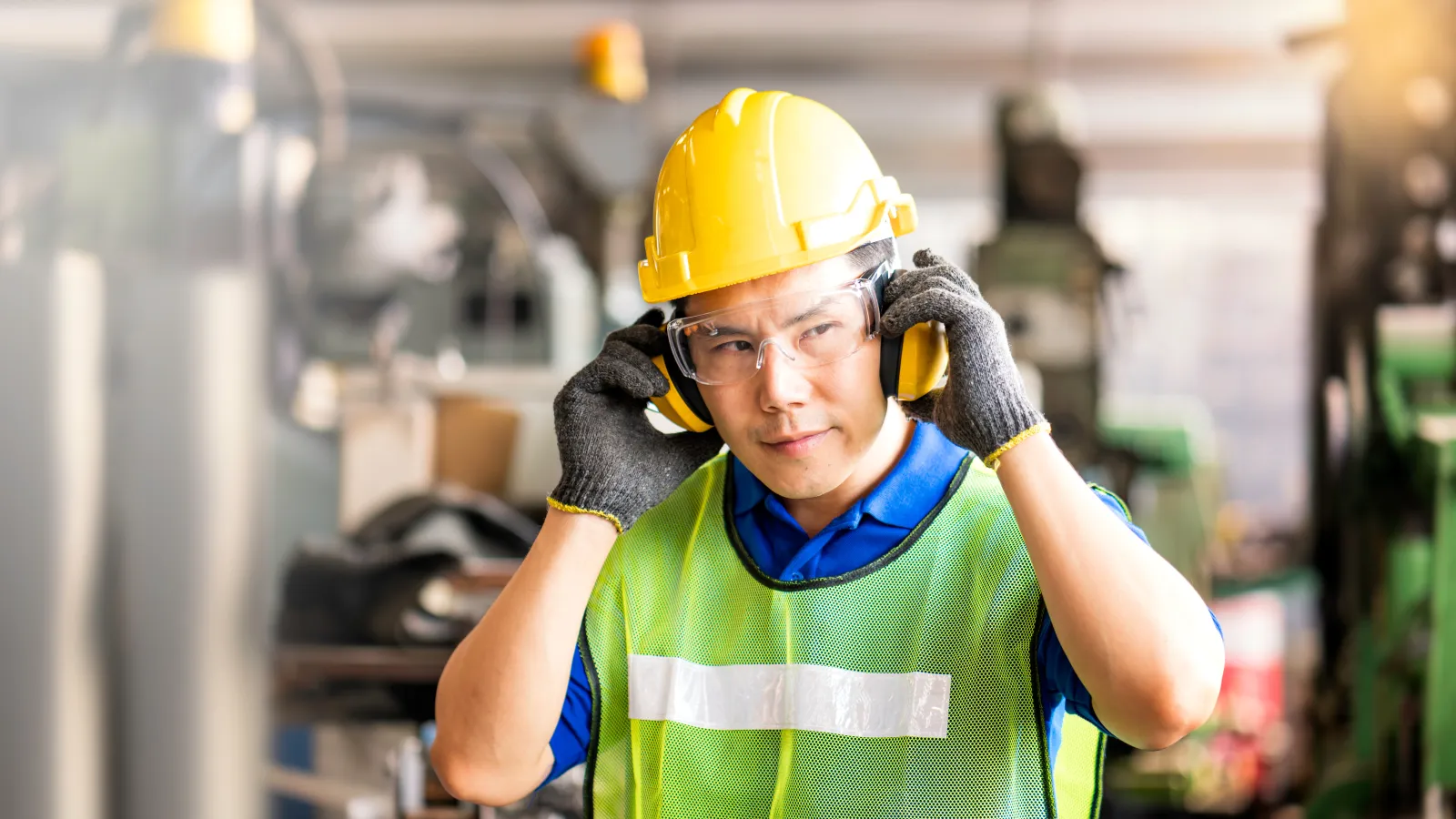 a person wearing a safety vest and a helmet