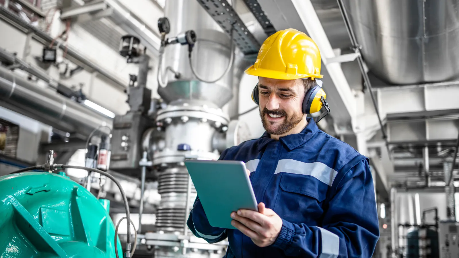 a man in a hard hat holding a tablet