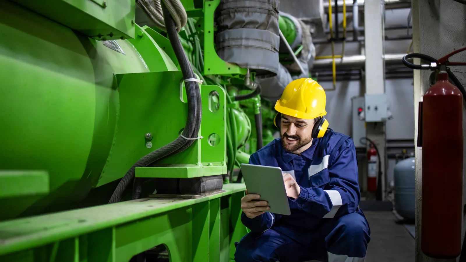 a person in a hard hat working on a piece of paper